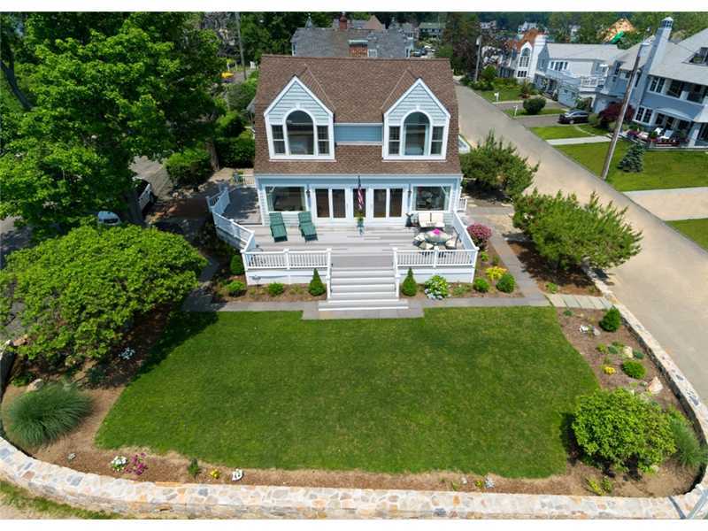 33 Ensign Road Rowayton, CT 06853 - Photo 3 of 16 a aerial view of a white house with a yard table and chairs