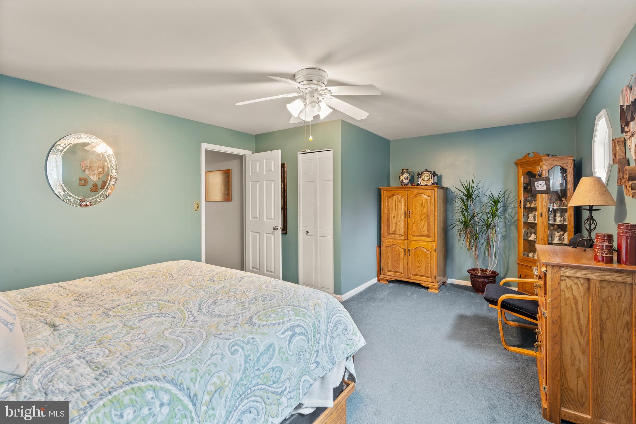 14 Stable Gate Court Perry Hall, MD 21128 - Photo 12 of 46 a bedroom with a bed and a chandelier