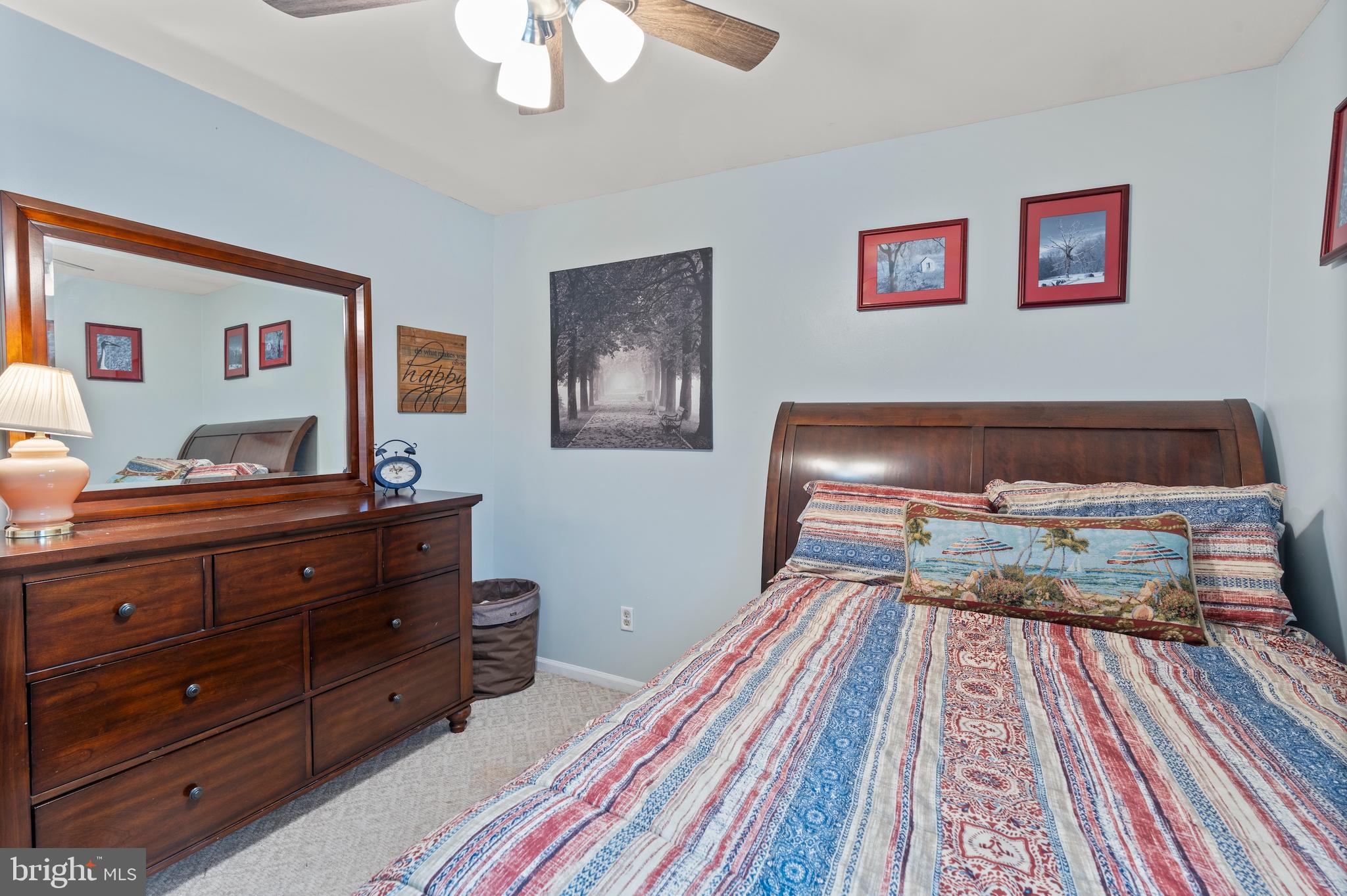 14 Stable Gate Court Perry Hall, MD 21128 - Photo 17 of 46 a bedroom with a bed and a lamp on dresser