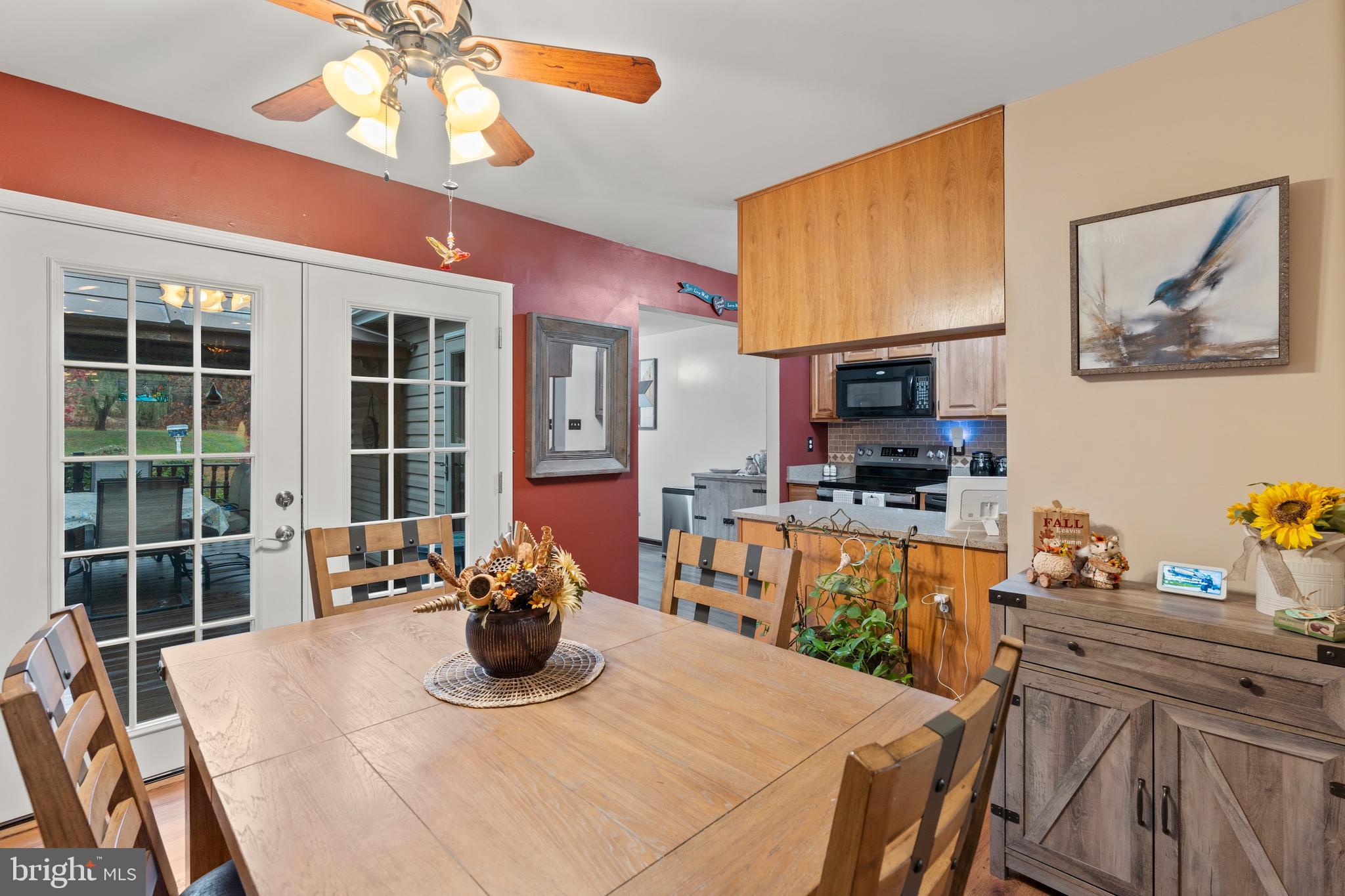 14 Stable Gate Court Perry Hall, MD 21128 - Photo 4 of 46 a kitchen with a table chairs refrigerator and microwave