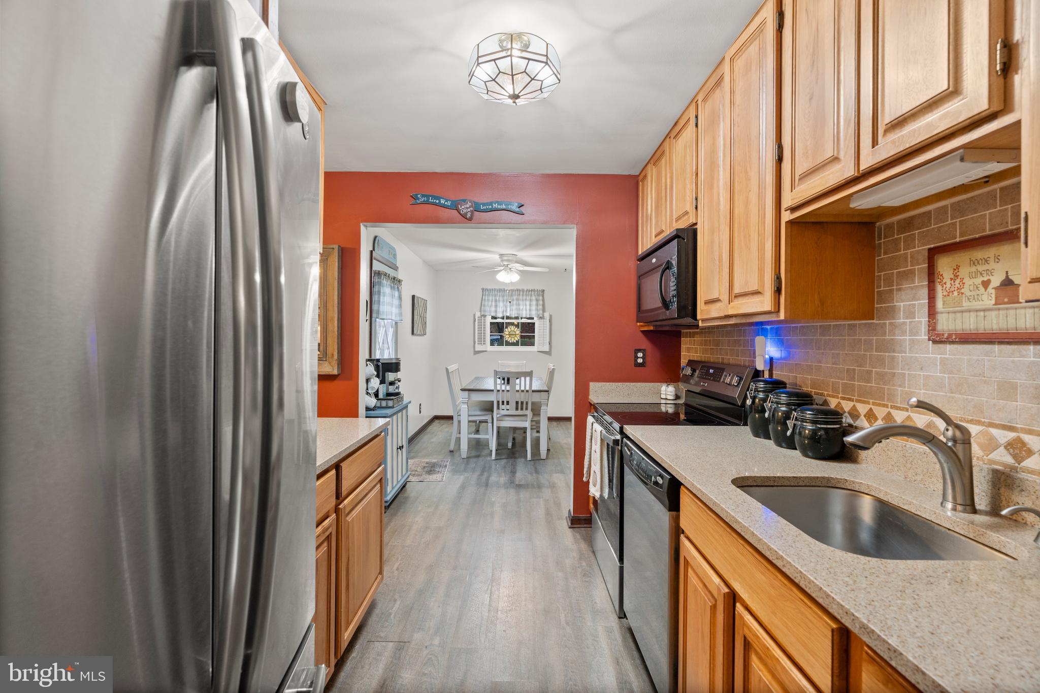 14 Stable Gate Court Perry Hall, MD 21128 - Photo 5 of 46 a kitchen with stainless steel appliances granite countertop a sink a stove and a refrigerator