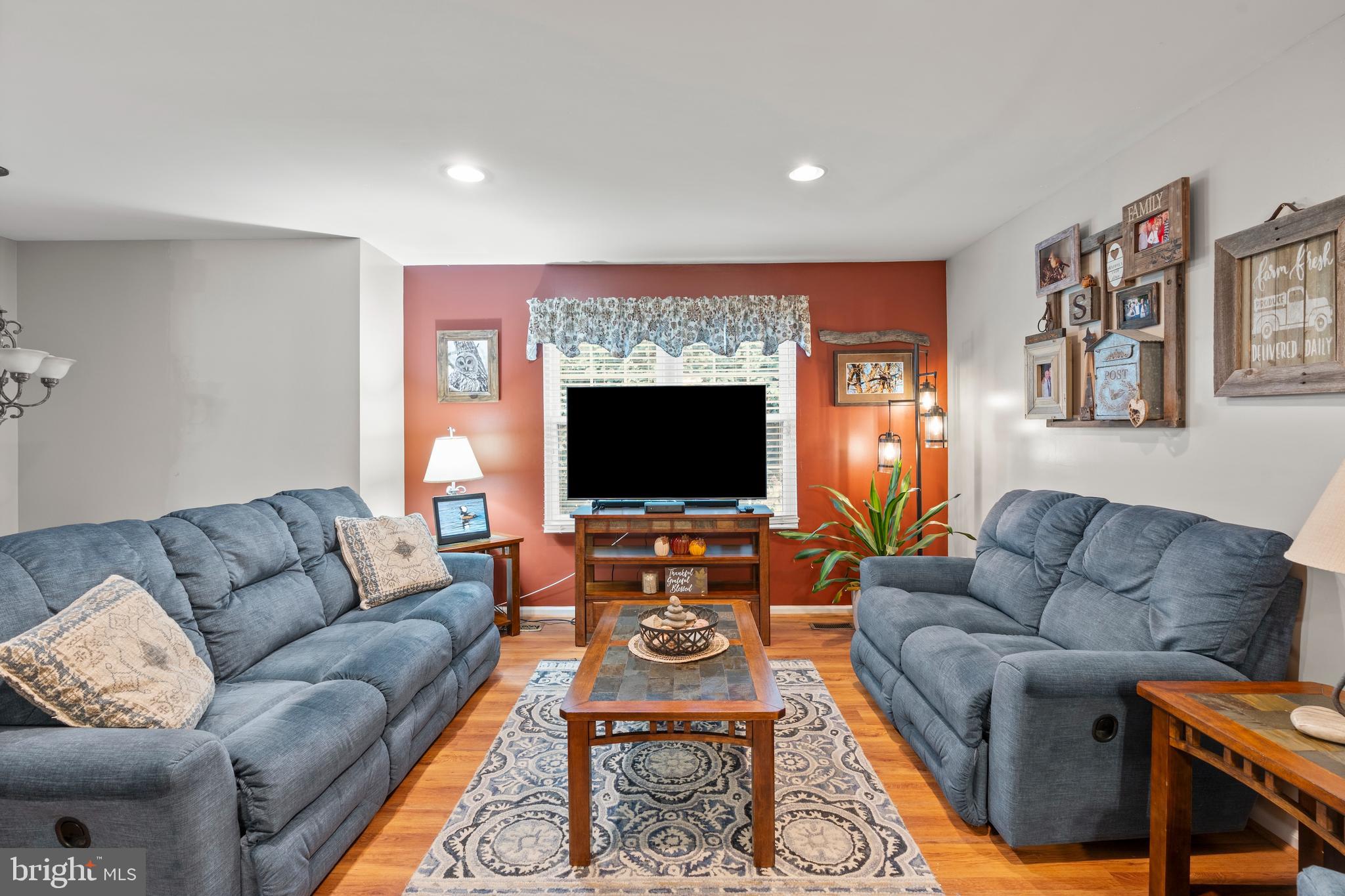14 Stable Gate Court Perry Hall, MD 21128 - Photo 9 of 46 a living room with furniture a flat screen tv and a fireplace