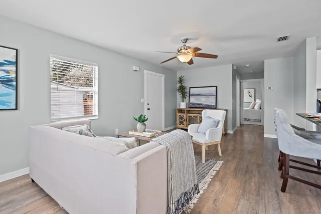 a living room with furniture and wooden floor