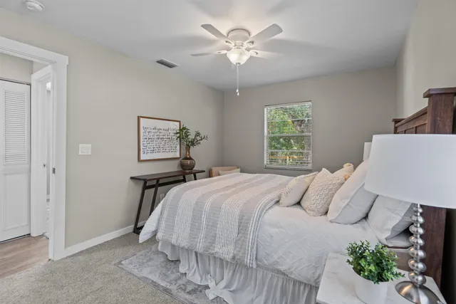 a bedroom with a large bed and a chandelier