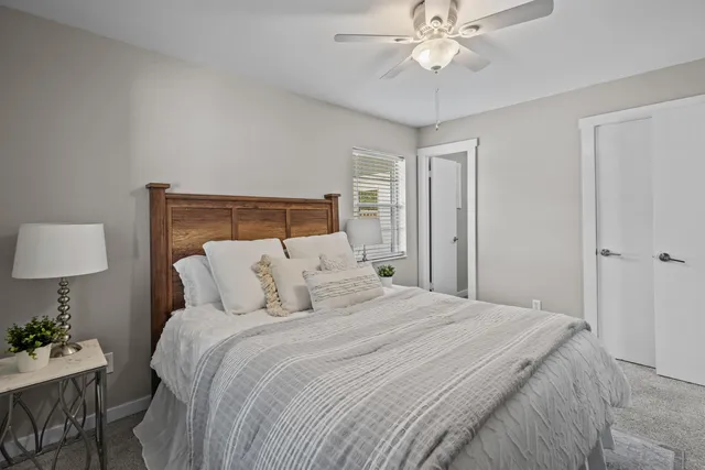 a bedroom with a bed and a chandelier