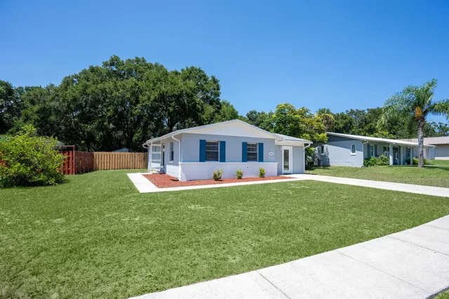 a front view of house with yard and green space