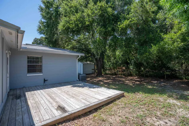 a view of a backyard with wooden fence