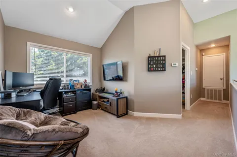 a livingroom with workspace and a couch
