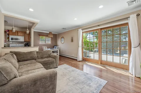 a living room with furniture and large windows