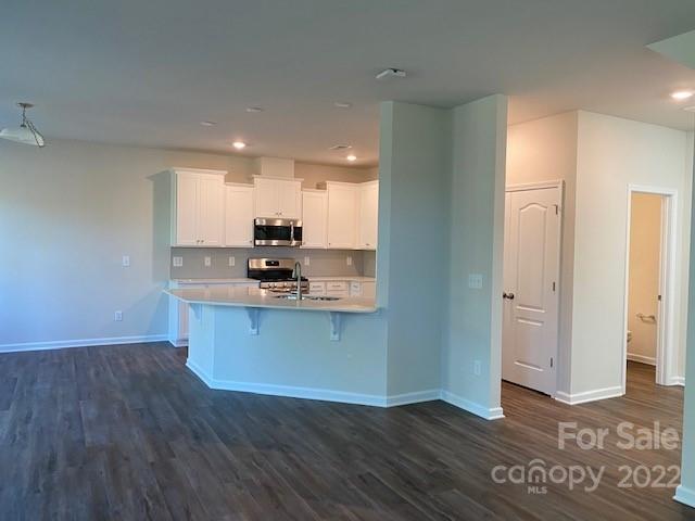 6550 Gopher Road, Unit 331 Lancaster, SC 29720 - Photo 5 of 12 a kitchen with stainless steel appliances granite countertop a refrigerator a stove and a wooden floors