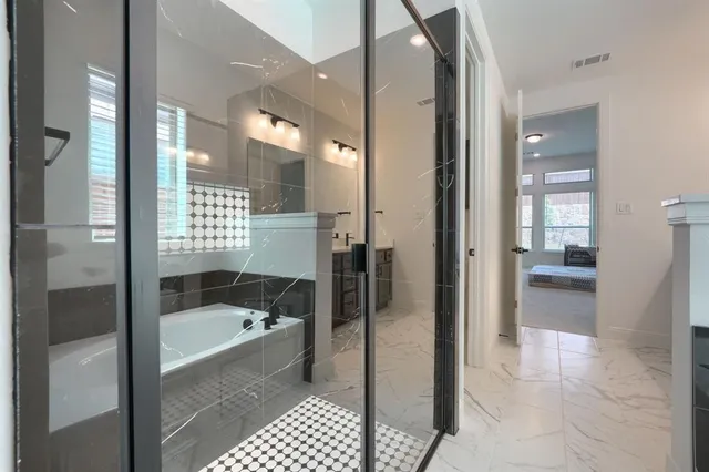 a bathroom with a bathtub and a window