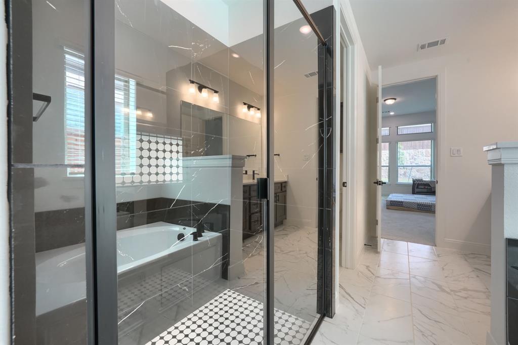 1348 Bay Laurel Road Fate, TX 75087 - Photo 14 of 27 a bathroom with a bathtub and a shower