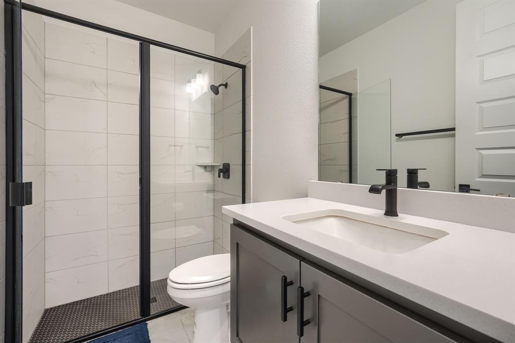 1348 Bay Laurel Road Fate, TX 75087 - Photo 22 of 27 a bathroom with a sink a toilet and shower