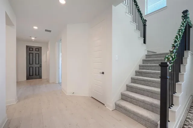 a view of entryway and hall with wooden floor
