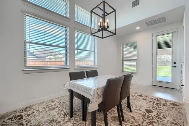 a dining room with furniture and wooden floor