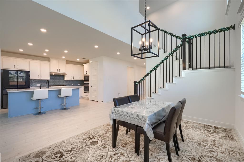 1348 Bay Laurel Road Fate, TX 75087 - Photo 9 of 27 a dining room with furniture and wooden floor