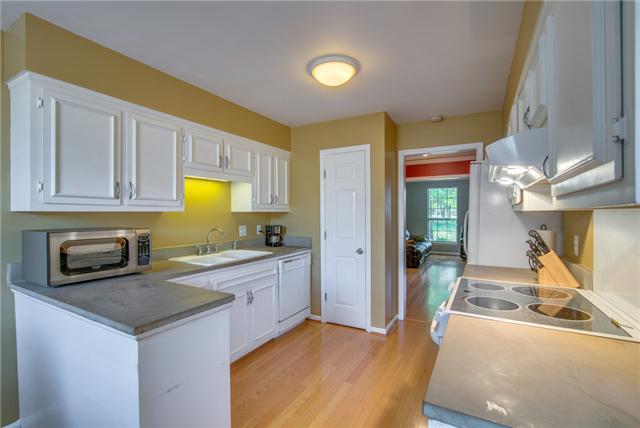 839 General George Patton Road, Unit 839 Nashville, TN 37221 - Photo 6 of 20 a kitchen with stainless steel appliances granite countertop a sink and a refrigerator