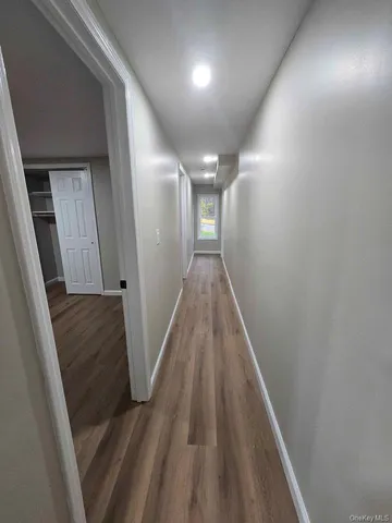 a bathroom with a toilet a sink a mirror and window