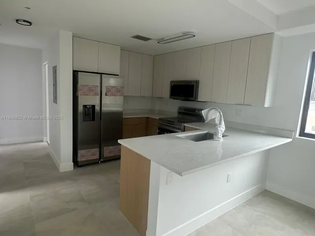 a view of empty room with windows and wardrobe