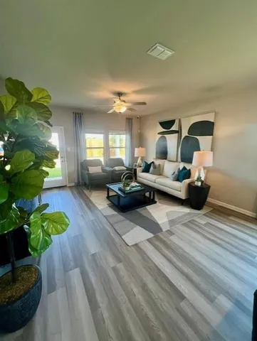 a living room with furniture and a chandelier