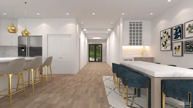 a kitchen with kitchen island stainless steel appliances a dining table chairs sink and cabinets