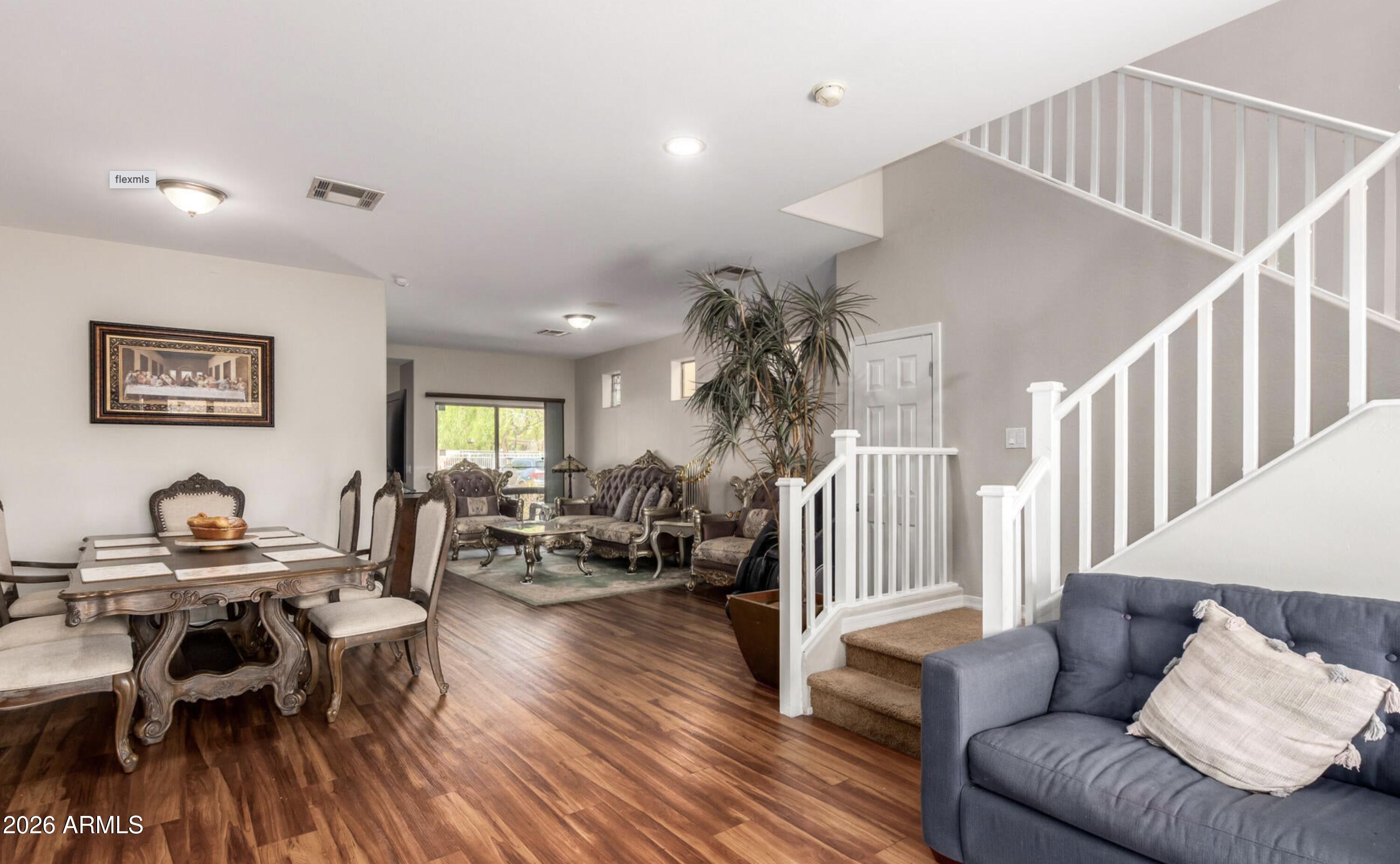 10225 West Camelback Road, Unit 12 Phoenix, AZ 85037 - Photo 6 of 19 a living room with furniture and wooden floor