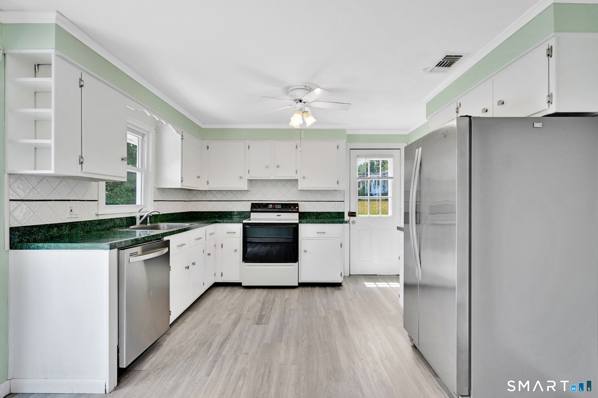 7 Rogers Drive Meriden, CT 06450 - Photo 13 of 40 a kitchen with a refrigerator a sink and dishwasher with wooden floor