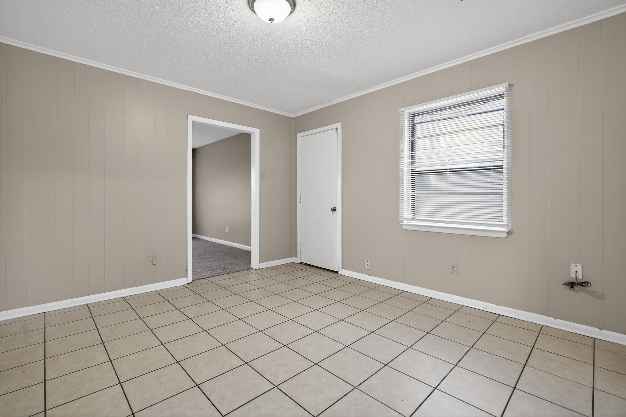 4566 Weaver Road Memphis, TN 38109 - Photo 7 of 32 a view of an empty room and window