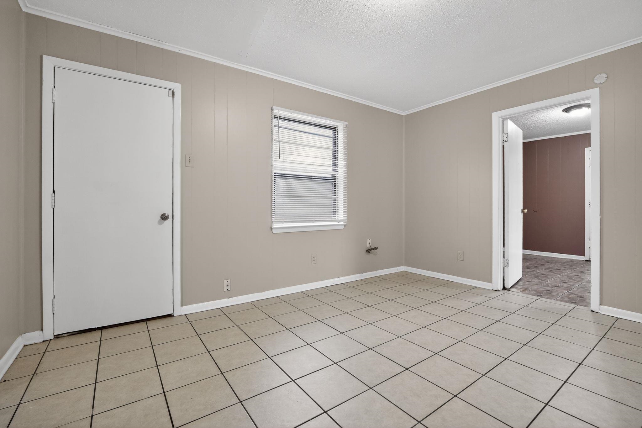 4566 Weaver Road Memphis, TN 38109 - Photo 8 of 32 a view of an empty room and window