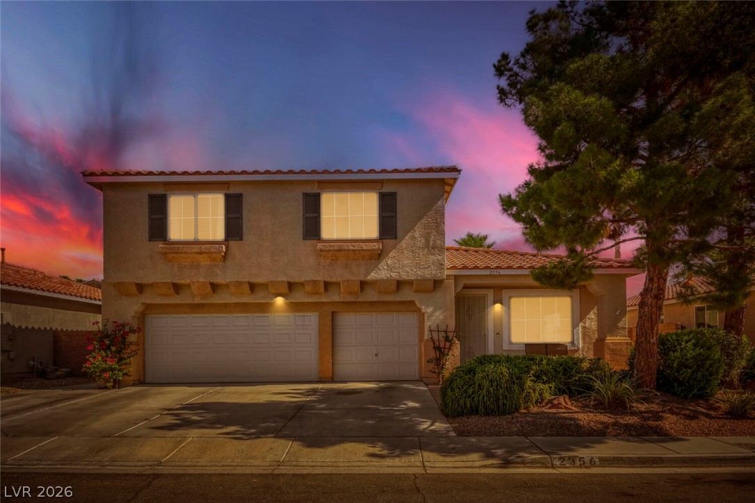 2356 Tilden Way Henderson, NV 89074 - Photo 3 of 30 A terracotta-tiled roof crowns this residence, featuring a two-car garage and mature landscaping.