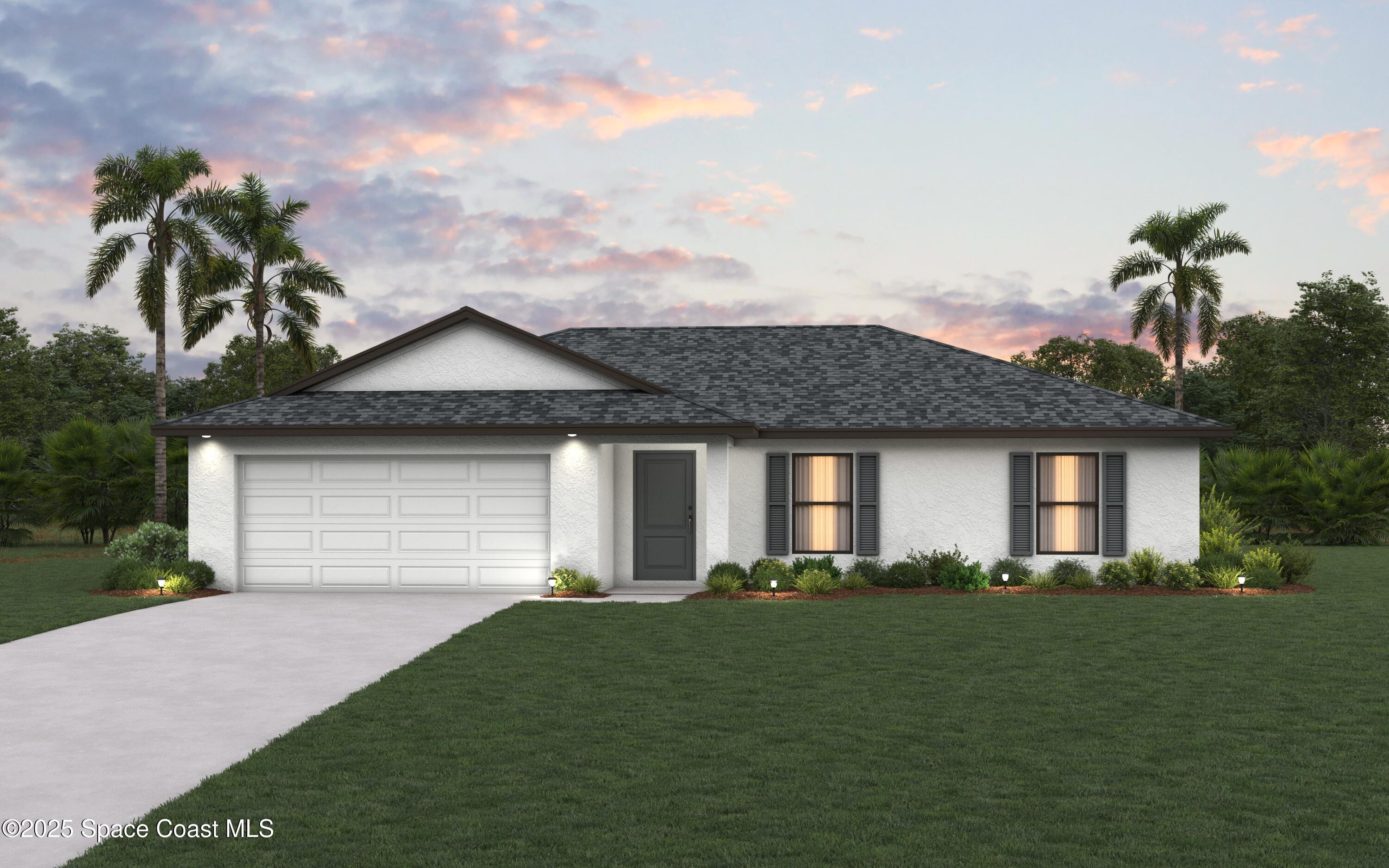 a front view of a house with a garden and yard