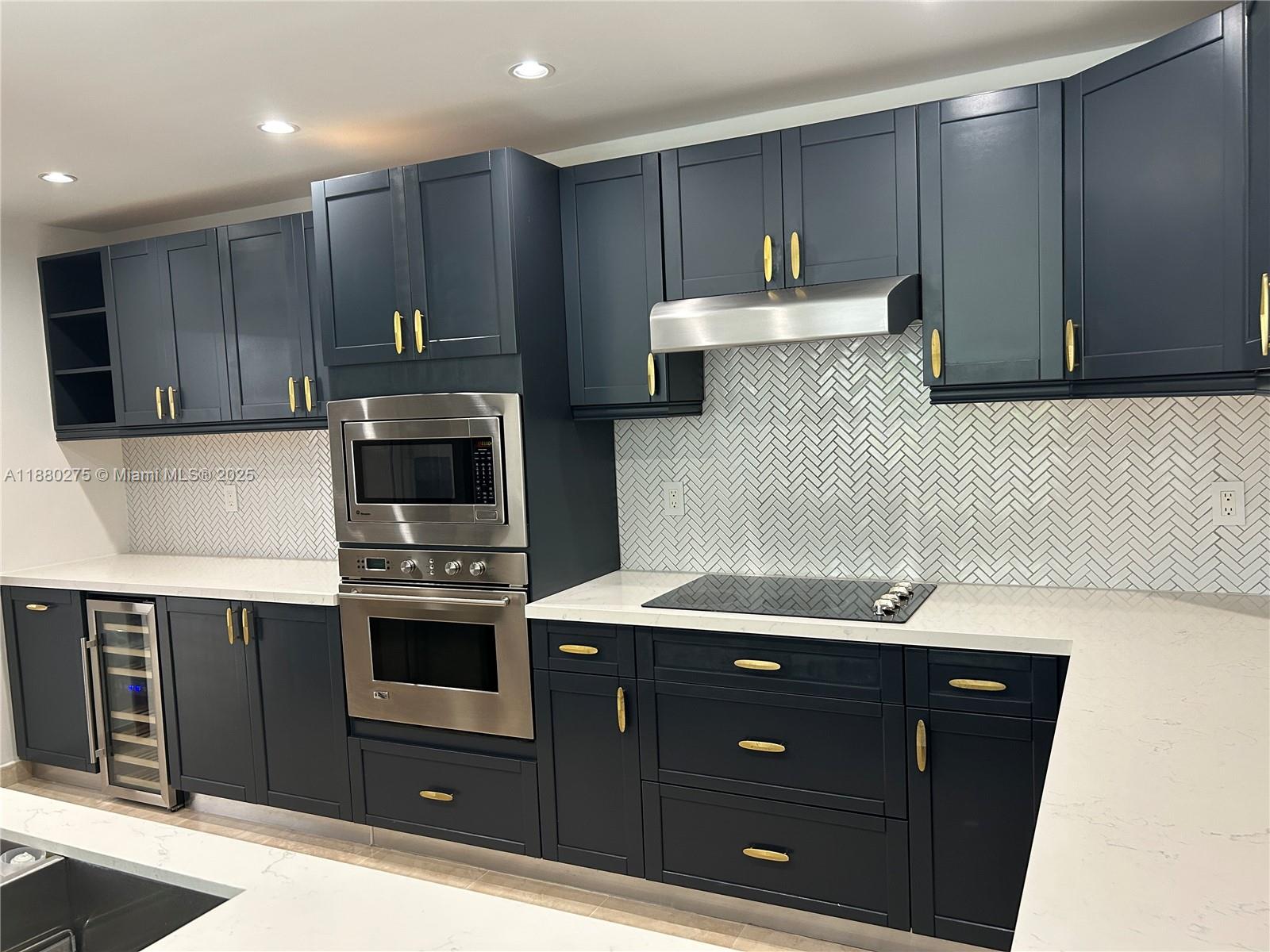 251 Crandon Boulevard, Unit 424 Key Biscayne, FL 33149 - Photo 11 of 22 a kitchen with a sink a stove and cabinets