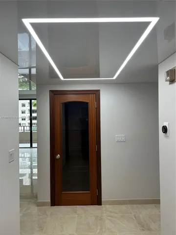 an entryway with a fan and a window