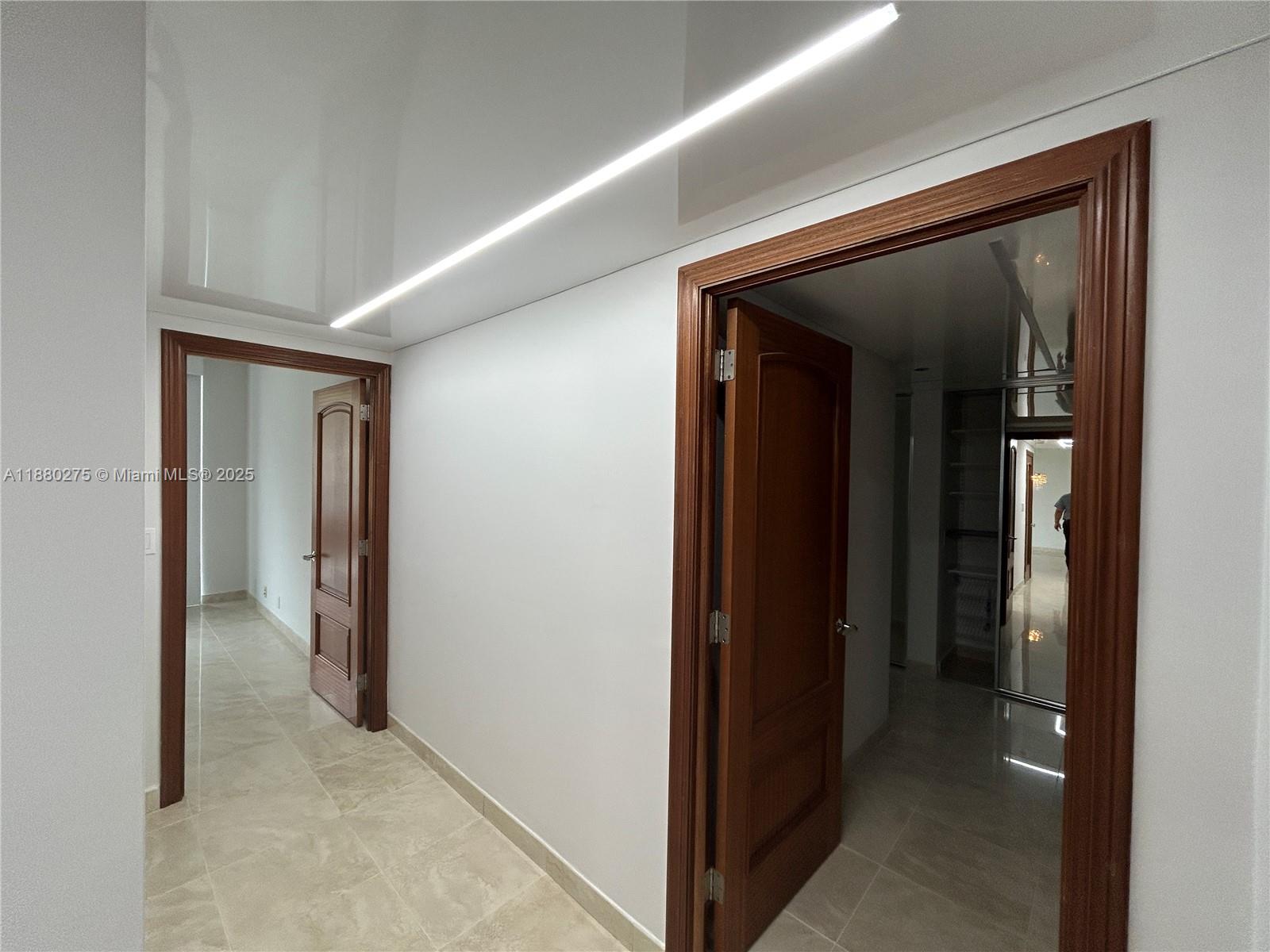 251 Crandon Boulevard, Unit 424 Key Biscayne, FL 33149 - Photo 13 of 22 a view of a hallway with closet and wooden floor