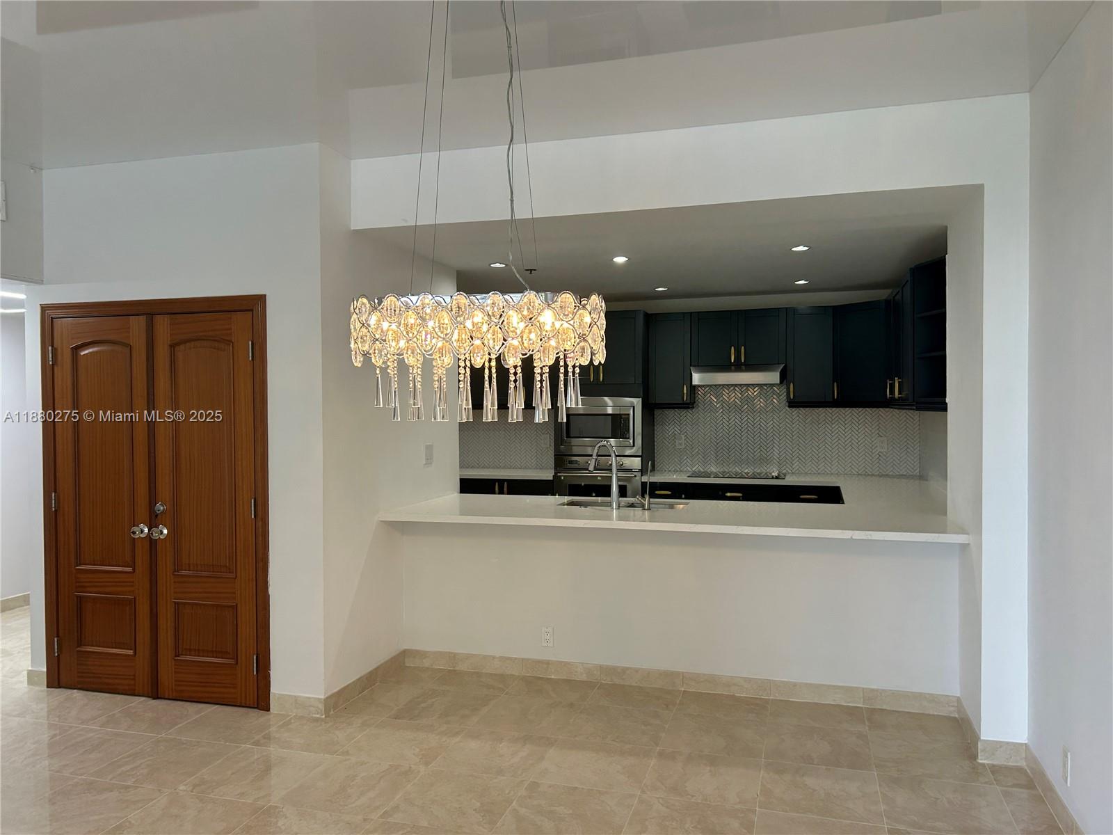 251 Crandon Boulevard, Unit 424 Key Biscayne, FL 33149 - Photo 5 of 22 an open kitchen with cabinets and wooden floor