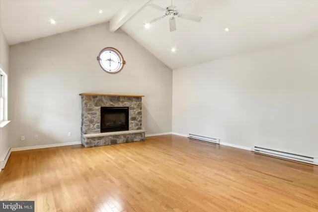 an empty room with a fireplace and a window