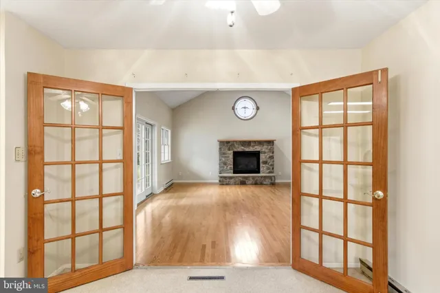 a view of an empty room with a fireplace and a window