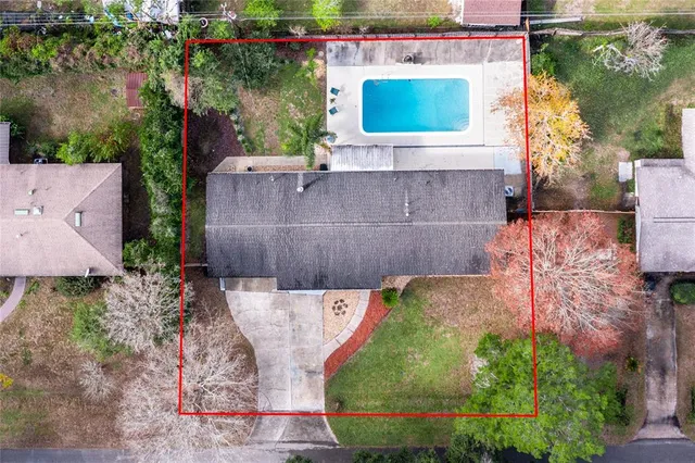 an aerial view of a house with a yard and a fountain
