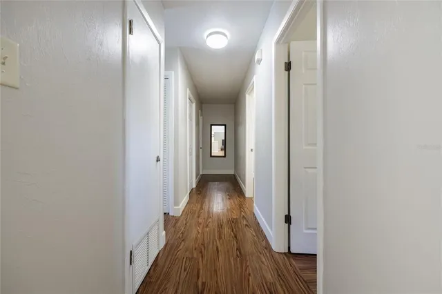 a view of a hallway with wooden floor