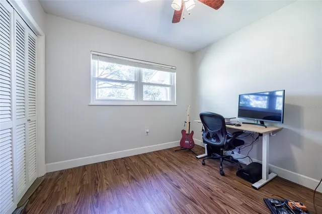 a view of workspace with wooden floor and windows