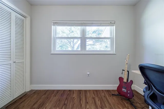 a room with hard wood floor and a window