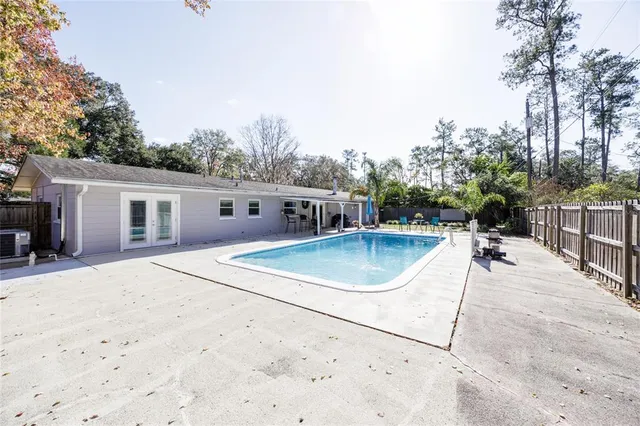 a view of a house with swimming pool and sitting area