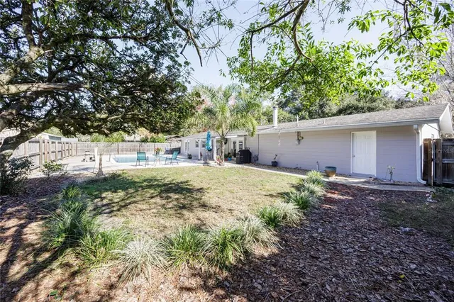 a view of a backyard with large trees