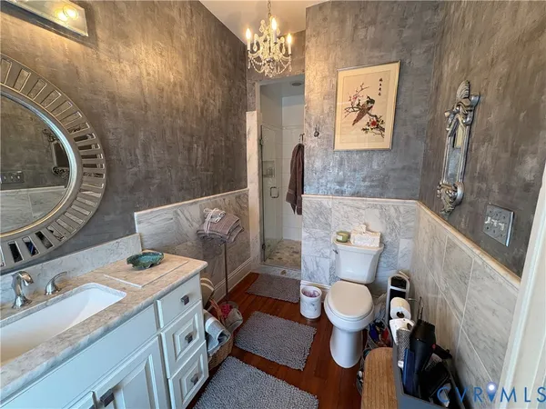 a bathroom with a sink mirror vanity and toilet