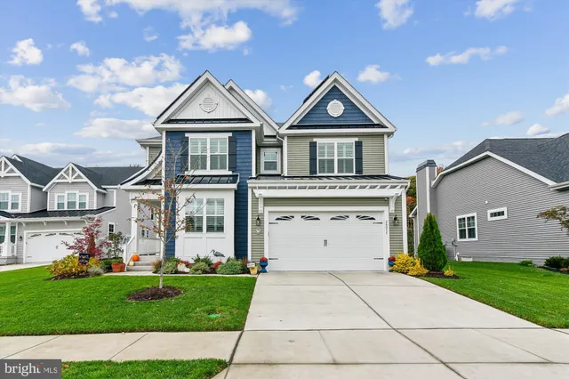 a front view of a house with a garden and plants