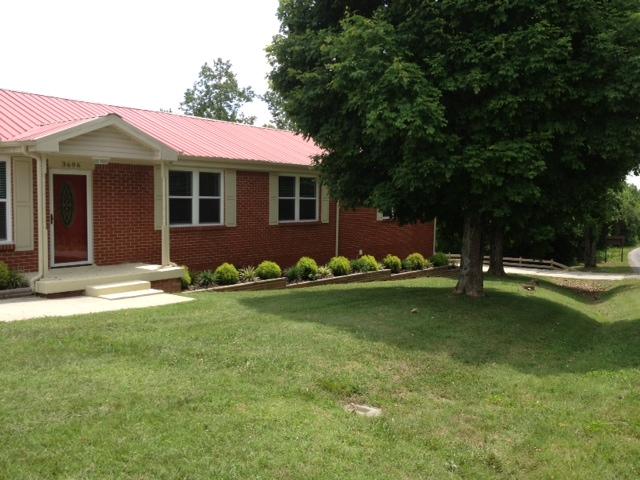 3696 Bowker Road Charlotte, TN 37036 - Photo 1 of 18 Another view of the front of the home. Landscaping, New Metal roof, New sidewalk, two stained glass entry doors. All new windows throughout. Priced to sell NOW. Serious offers only please.