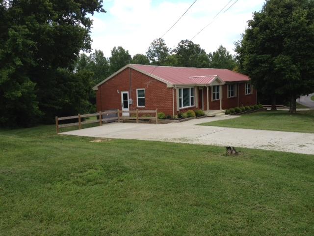 3696 Bowker Road Charlotte, TN 37036 - Photo 18 of 18 View of the other side of the home. Note the concrete. You could easily add a carport to either side if desired. The old well could be redone and used to water a large garden or farm animals. This could be the mini farm you have been dreaming about