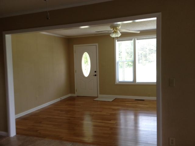 3696 Bowker Road Charlotte, TN 37036 - Photo 9 of 18 Living room has gleaming new HARDWOOD flooring. No laminate in this home.Its the real thing. Beautiful stained glass entry door. Plantation shutters. Opens to the huge kitchen for your family gatherings.