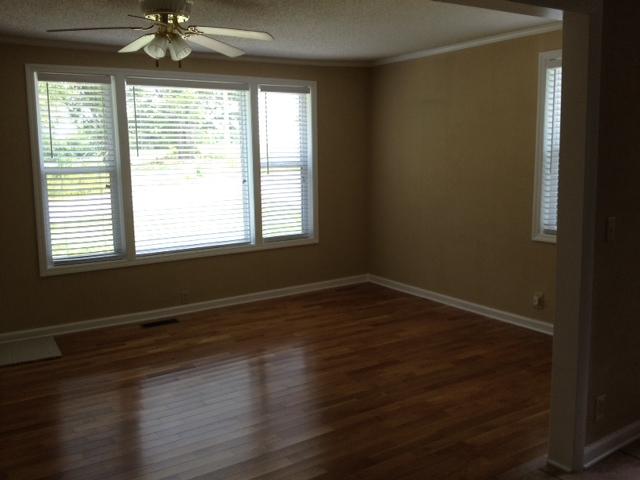 3696 Bowker Road Charlotte, TN 37036 - Photo 10 of 18 Another view of the living room showing the large triple window ( New) and another window letting the sunshire in. Bright and cheery. All New, clean , Pretty, ready.Fan lights in several rooms have two light options- one for dim & one for bright. COO