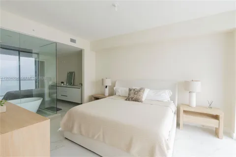 a bathroom with a double vanity sink toilet and shower